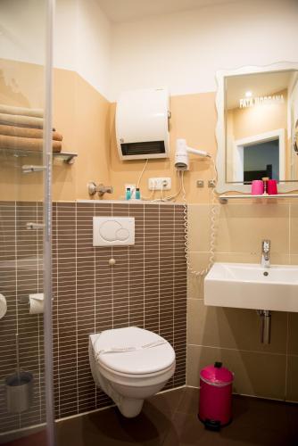 a bathroom with a toilet and a sink at Hotel Sandmanns am Dom in Cologne