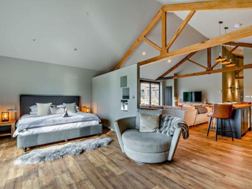 a bedroom with a bed and a chair and a couch at 1 Bed in Leeds 89862 in Sherburn in Elmet