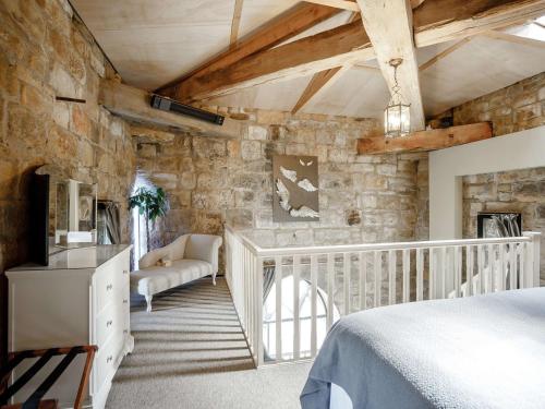 a bedroom with a bed and a stone wall at 1 bed property in Alnwick 82212 in Alnwick