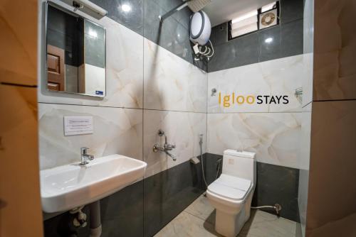 a bathroom with a sink and a toilet at Igloo Stays Kakkanad in Kakkanad