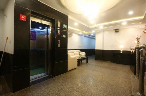 a living room with a couch and a room with at Hotel Luck Recdancy mahipalpur in New Delhi