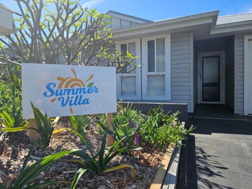 a sign for a summer villa in front of a house at Summer Villa in Kiama