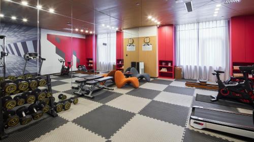 a gym with treadmills and exercise equipment in a room at Mercure Xi'an Daming Palace in Xi'an