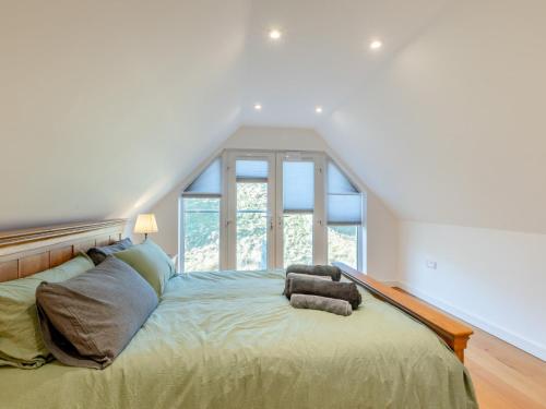 a bedroom with a bed with a large window at 4 Bed in Hawick 95856 in Hawick