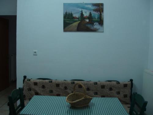 a dining room with a table with a basket on it at Splantza Apartments in Ammoudia