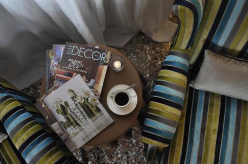 a table with a cup of coffee and a book at Casa Colleoni in Venice