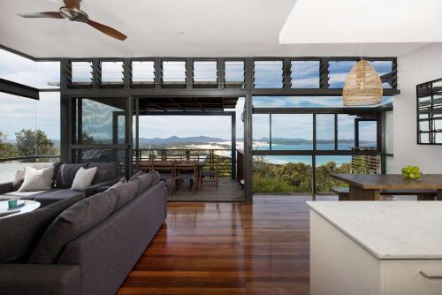 a living room with a couch and a table at One Mile Retreat in Anna Bay