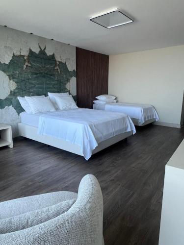 a hotel room with two beds and a couch at Şahin Tepesi Suites - Manzaralı lüks Suit in Rize