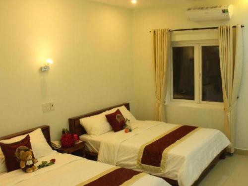 a bedroom with two beds with teddy bears on them at Bong Mai Motel in Da Nang