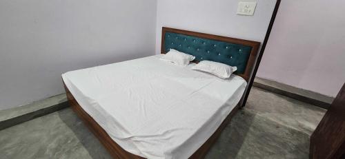 a bed with two pillows on it in a room at HOTEL O BLUE ROSE in Sītāpur