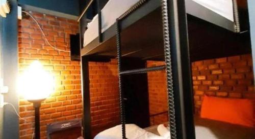 a room with a hanging bed and a lamp at The Royal Chiangkhan Boutique Hotel in Chiang Khan