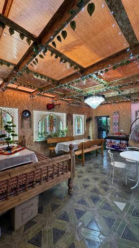 a room with benches and tables in a building at Hotel Ravshanbek in Samarkand