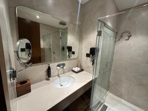 a bathroom with a sink and a shower at Shanti Sarovar Haridwar in Haridwār
