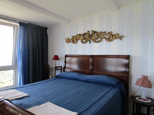 マッサ・ルブレンセにあるVilla Staraceのベッドルーム1室(青いシーツと窓付)