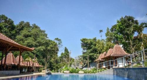 a resort with a swimming pool and some buildings at VillaTel Salse in Cicadas