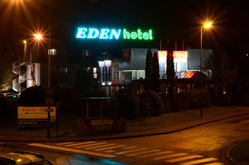 a neon sign for a eden hotel at night at The Originals City, Hôtel Éden, Rouen Nord in Bois-Guillaume