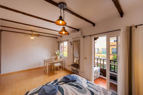 a bedroom with a bed and a table with a desk at Sweet Home Botanico in Adeje