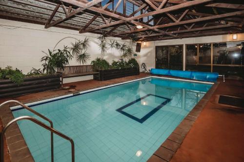a large swimming pool in a building at Family Fun - 4BR home with swimming pool and spa in New Plymouth