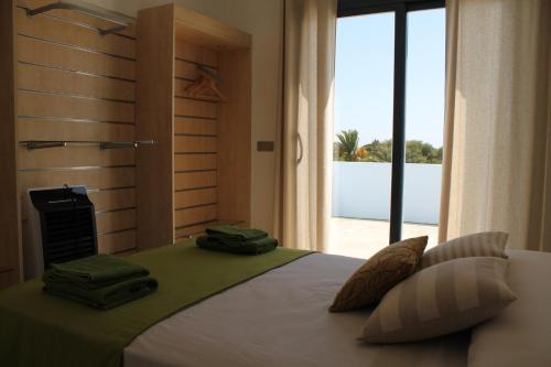 a bedroom with a bed with a view of the ocean at Villa Romaní Apartament in Ciutadella