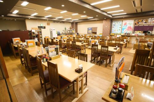 an empty dining room with tables and chairs at Kur and Hotel Suruga in Shizuoka