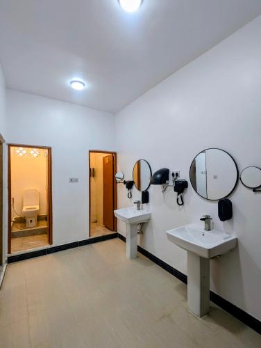 a bathroom with two sinks and mirrors on the wall at Bellimena Stone Town in Zanzibar City