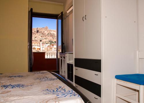 a bedroom with a bed and a view of a mountain at B&B Nonna Sini in Castelsardo