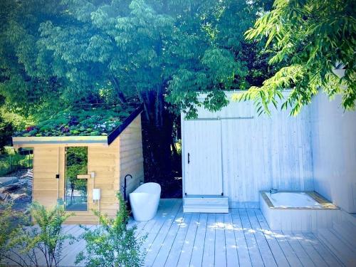 a small shed with a toilet on a patio at スターハウス in Otsu