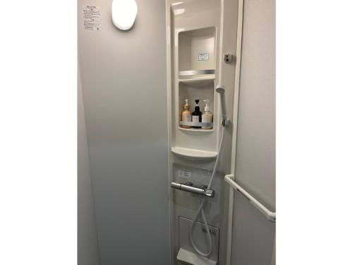 a bathroom with a refrigerator with bottles in it at GUEST HOUSE aoshima tei - Vacation STAY 42002v in Miyazaki