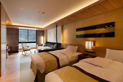 a hotel room with two beds and a couch at Gifu Grand Hotel in Gifu