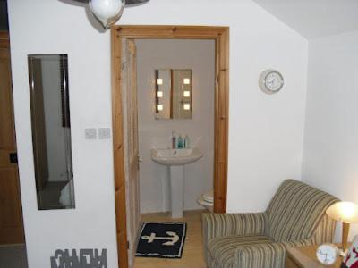 a living room with a couch and a sink at Langland Road B&B in The Mumbles