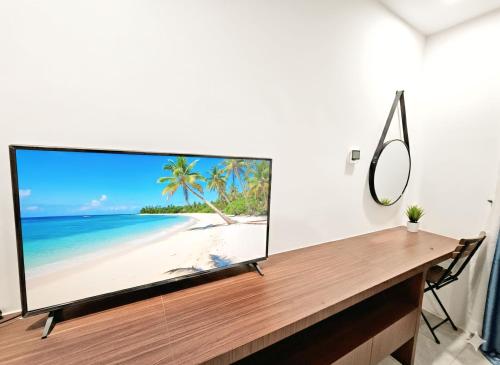 a flat screen tv sitting on top of a table at The Step Hotel kampot in Kampot