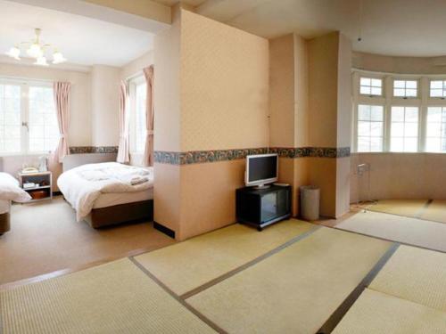 Postel nebo postele na pokoji v ubytování Hakuba Sun Valley Hotel