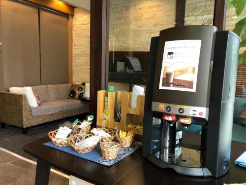 a coffee machine on a table in a living room at Hotel Bougainvillea Akebonobashi in Tokyo