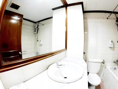 a bathroom with a toilet and a sink at Adamson Hotel Kuala Lumpur in Kuala Lumpur