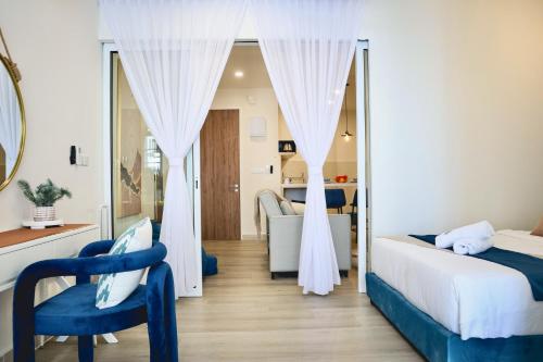 a hotel room with two beds and a mirror at Homesuite' Home at The Shore in Kota Kinabalu