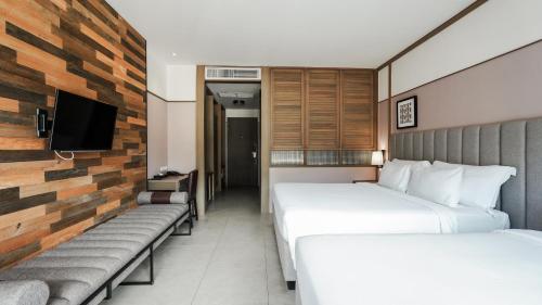 a hotel room with two beds and a tv at Sugar Marina Hotel CLIFFHANGER Aonang in Ao Nang Beach