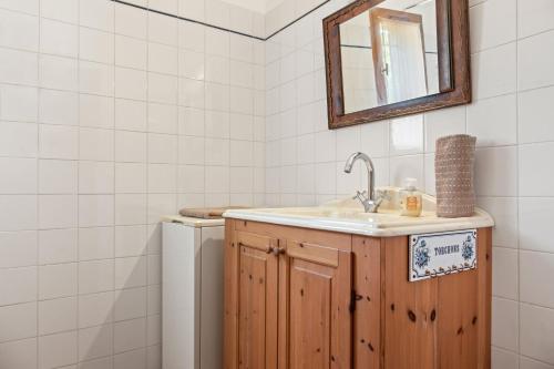 a bathroom with a sink and a mirror at La Bignone in Régusse