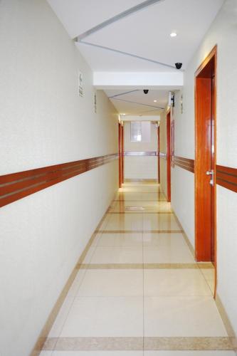 an empty corridor in an office building with a door at Gran Mundo Hotel & Suites in Lima