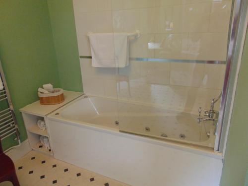 a bathroom with a bath tub with a shower at Holywell House in Loughborough