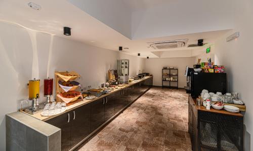 a kitchen with a long line of counters in a room at Johann Strauss Hotel in Bucharest