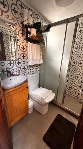 a bathroom with a toilet and a sink and a shower at Urbana - Ayvalık in Ayvalık