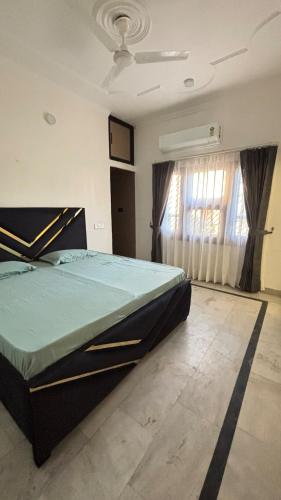 a bedroom with a large bed and a window at ProxyHome in Kālka