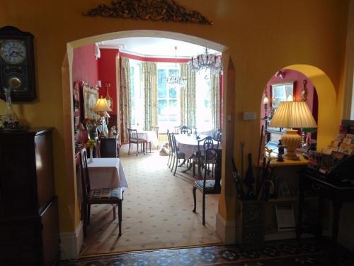 a dining room with an archway and a table and chairs at Holywell House in Loughborough