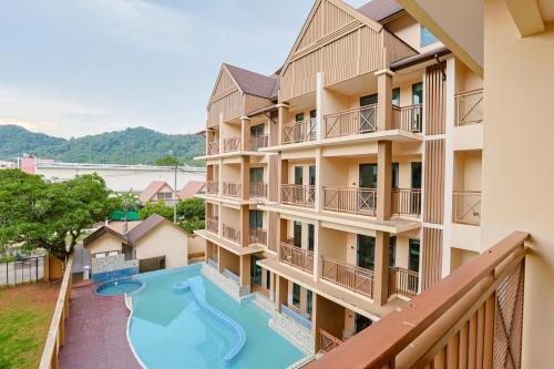 an apartment building with a swimming pool and a balcony at Aqua Resort Aonang Krabi in Ao Nang Beach