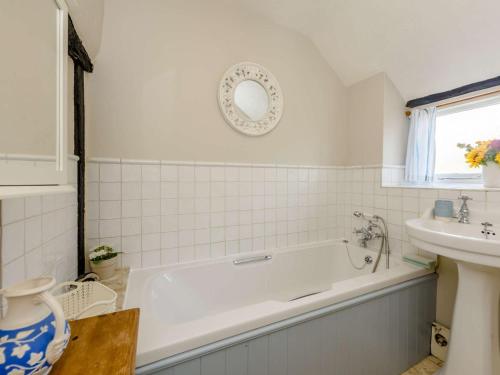 a white bathroom with a tub and a sink at 1 bed in Sedlescombe 83845 in Sedlescombe