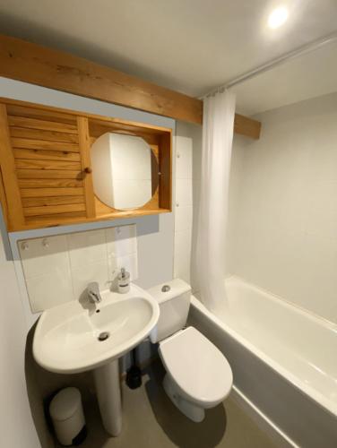 a small bathroom with a toilet and a sink at Hôtel de La Plage - WISSANT in Wissant