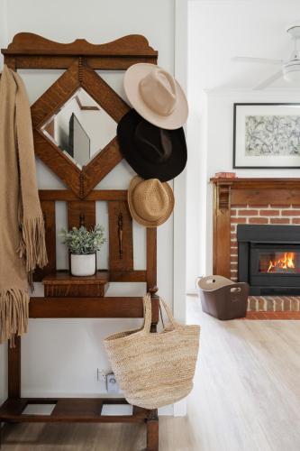 a room with a hat and a fireplace at The Old Library in Balnarring Beach