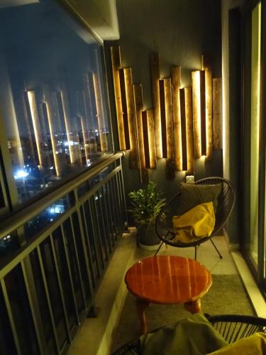 a room with a balcony with a view of the city at Cozy Top-Floor Apartment with Balcony & City Views near United Nations Office in Ruaka