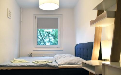 une chambre avec un lit bleu et une fenêtre dans l'établissement GUWO Gästewohnung Platanenstraße 1, à Sprucke