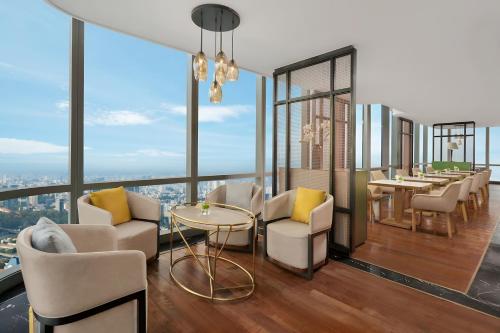 a restaurant with a view of the city at The Grand Residence at Vinhomes in Ho Chi Minh City